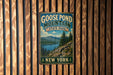 A vintage-style metal sign for Goose Pond Mountain State Park in New York, featuring a scenic landscape with mountains, pine trees, and a lake.