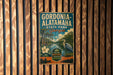 A vintage metal sign for Gordonia Alataha State Park in Georgia, featuring a scenic illustration of the park's natural surroundings.