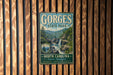 A vintage metal sign for Gorges State Park in North Carolina, featuring a scenic image of a waterfall surrounded by lush forests.
