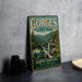 A vintage-style metal sign for Gorges State Park, featuring a scenic image of the park's natural beauty.