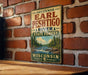 A vintage-style metal sign displaying the name "Earl Peschigo River State Forest Wisconsin" is mounted on a brick wall.