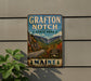 A vintage metal sign for Grafton Notch State Park in Maine, featuring a scenic mountain landscape with a winding road and autumn foliage.