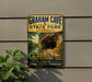 A vintage-style metal sign for Graham Cave State Park in Missouri, featuring a scenic image of the cave and a path leading through it.