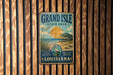 A vintage metal sign for Grand Isle State Park in Louisiana, featuring a beach scene with a lighthouse and a bird.