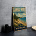 A vintage-style metal sign for Grand Mere State Park in Michigan, featuring a scenic landscape with a beach, mountains, and a pine tree.