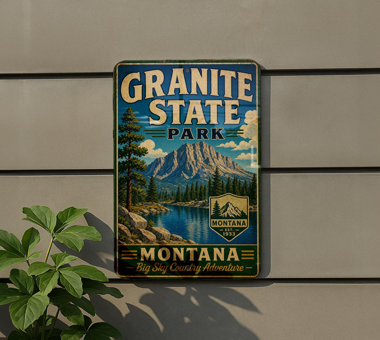 A vintage-style metal sign for Granite State Park, featuring a mountain landscape and a river, mounted on a wall.