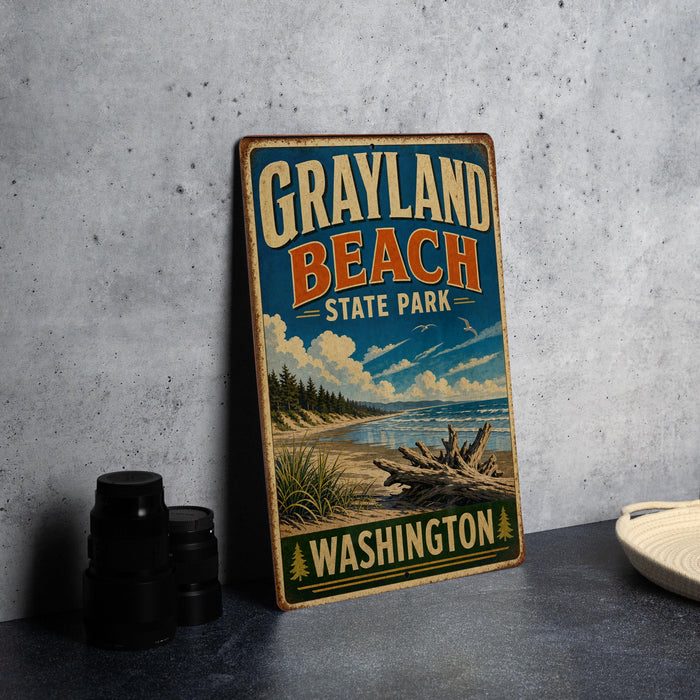 A vintage-style metal sign for Grayland Beach State Park in Washington, featuring a scenic landscape with a beach, mountains, and a cloudy sky.