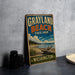 A vintage-style metal sign for Grayland Beach State Park in Washington, featuring a scenic landscape with a beach, mountains, and a cloudy sky.