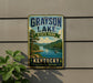 A vintage-style sign for Grayson Lake State Park in Kentucky, featuring a scenic landscape with a lake, mountains, and a boat on the water.