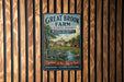 A vintage metal sign for Great Brook Farm State Park in Massachusetts, featuring a scenic illustration of a farm and a river.
