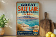 A vintage-style sign for Great Salt Lake State Park in Utah, featuring a scenic landscape with mountains, water, and a lake.