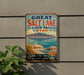 A vintage-style metal sign advertising the Great Salt Lake State Park in Utah, featuring a scenic landscape with mountains, water, and a cloudy sky.