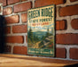 A vintage-style metal sign for the Green Ridge State Forest in Maryland, featuring a scenic mountain landscape with pine trees and a winding trail.