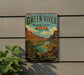 A vintage-style sign for Green River State Park in Utah, featuring a scenic landscape with mountains, a river, and lush vegetation.