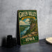 A vintage-style sign for Green Valley State Park in Iowa, featuring a scenic landscape with a river, cliffs, and trees.