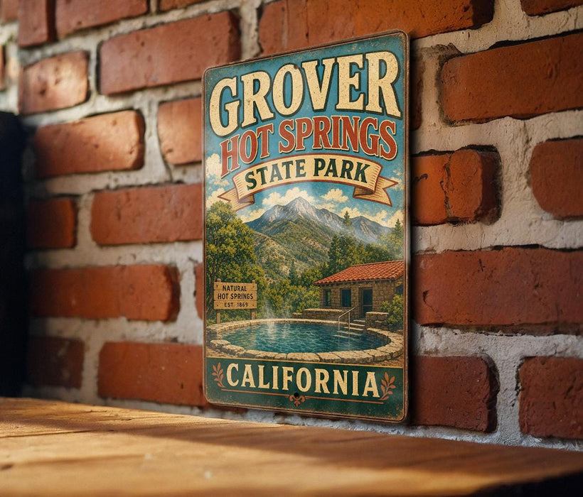 A vintage-style metal sign for Grover Hot Springs State Park in California, featuring a scenic illustration of the park's natural hot springs and mountains.