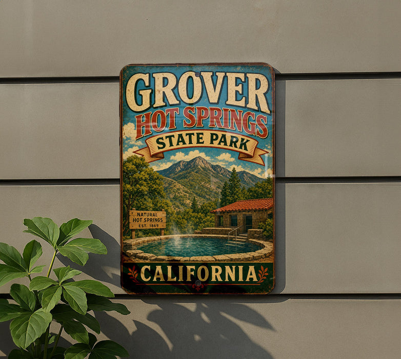 A vintage-style sign for Grover Hot Springs State Park in California, featuring a scenic image of the hot springs and mountains.