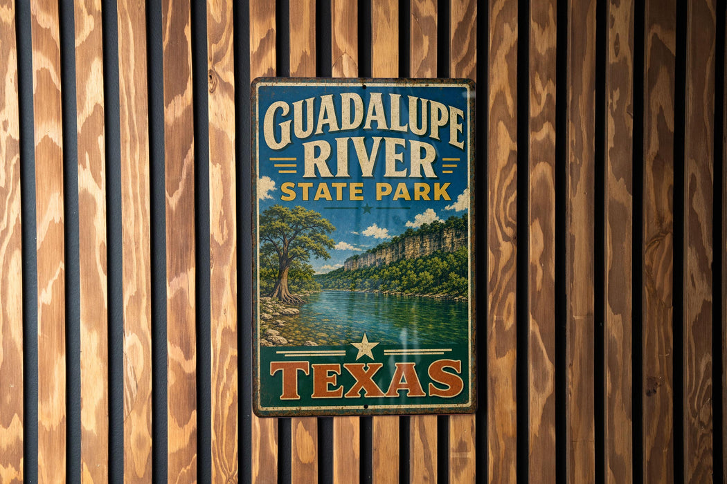 A vintage metal sign for Guadalupe River State Park in Texas, featuring a scenic landscape with a river and mountains.