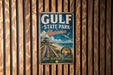 A vintage metal sign for Gulf State Park, Alabama, mounted on a wooden wall.