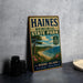 A vintage metal sign for Haines Memorial State Park, featuring a scenic coastal landscape with a beach, ocean, and trees.