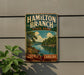 A vintage metal sign for Hamilton Branch State Park in South Carolina, featuring a scenic landscape with a river and trees.