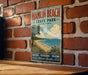 A vintage-style sign for Hamlin Beach State Park in New York, featuring a beach scene with a tree and a body of water.