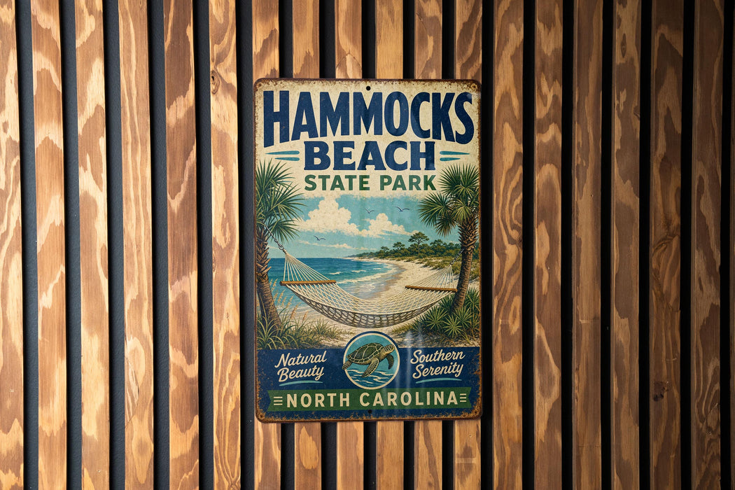 A vintage metal sign for Hammocks Beach State Park in North Carolina, featuring a beach scene with palm trees and a hammock.