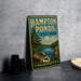 A vintage metal sign for Hampton Ponds State Park in Massachusetts, featuring a scenic landscape with a lake, trees, and mountains.