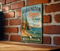 A vintage metal sign for Harrington Beach State Park in Wisconsin, featuring a scenic image of the beach and cliffs.