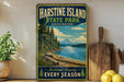 A vintage-style sign for Harstine Island State Park in Washington, featuring a scenic landscape with a mountain, pine trees, and a lake.