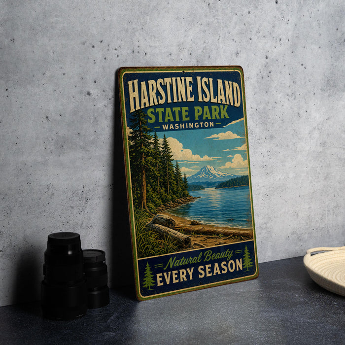 A vintage-style metal sign for Harstine Island State Park in Washington, featuring a scenic landscape with a mountain, pine trees, and a lake.