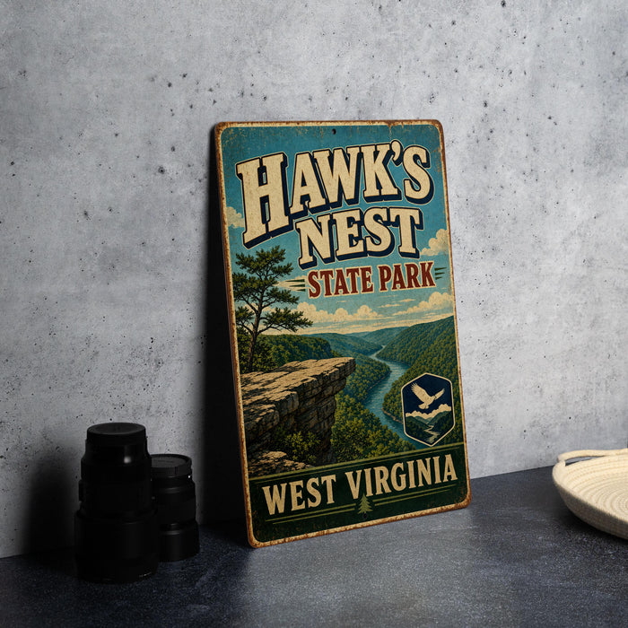 A vintage-style sign for Hawk's Nest State Park in West Virginia, featuring a scenic landscape with a river and mountains.