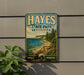 A vintage-style metal sign for Hayes State Park, Michigan, featuring a scenic landscape with a beach, mountains, and pine trees.