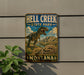 A metal sign with a dinosaur illustration and the text "HELL CREEK STATE PARK MISSOURI" is displayed on a wall.