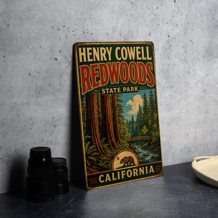 A vintage-style metal sign for Henry Cowell Redwoods State Park in California, featuring a scenic illustration of the park's iconic redwood trees and a river.