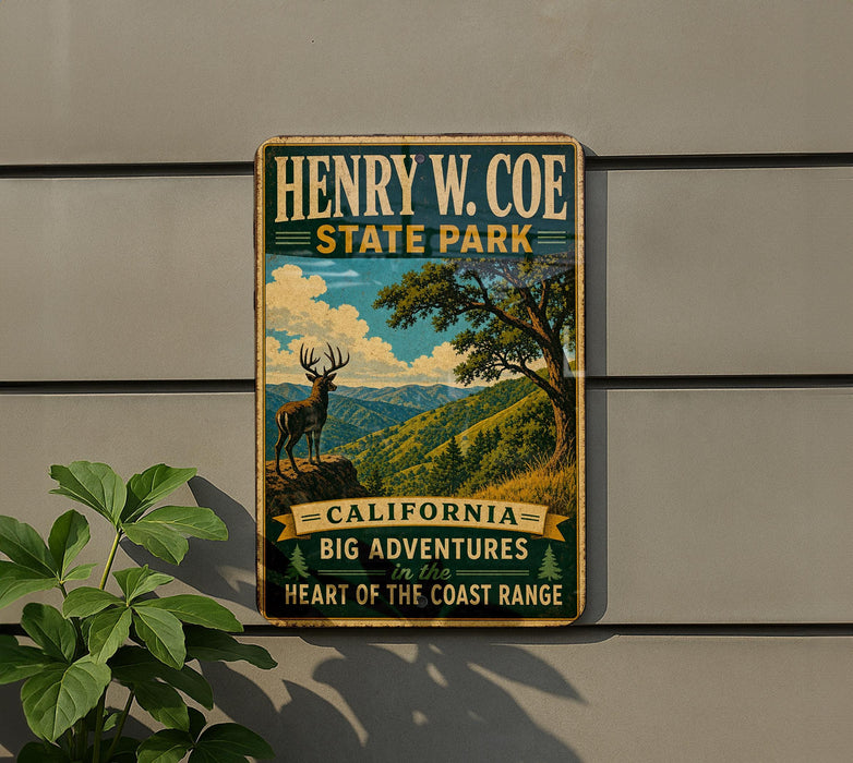 A vintage-style metal sign for Henry W. Coe State Park, featuring a scenic landscape with a deer and mountains in the background.