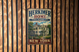 A vintage-style metal sign for the Herkimer Home State Historic Site in New York, featuring a house illustration and the text "Herkimer Home State Historic Site New York".