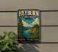 A vintage-style metal sign for Heyburn State Park, Idaho, featuring a scenic landscape with a lake, mountains, and pine trees.