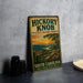 A vintage-style sign for Hickory Knob State Resort Park, featuring a scenic landscape with mountains, trees, and a sunset.