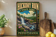 A vintage-style sign for Hickory Run State Park in Pennsylvania, featuring a scenic landscape with a waterfall and pine trees.