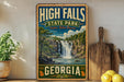 A vintage-style sign for High Falls State Park in Georgia, featuring a waterfall and lush greenery, is displayed on a shelf next to a wooden cutting board and some lemons.