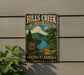 A vintage-style metal sign for Hills Creek State Park in Pennsylvania, featuring a scenic landscape with a river, mountains, and a picnic area.