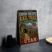 A vintage-style metal sign for the historic Union Pacific Rail Trail in Utah, featuring a scenic image of a tunnel and mountains.
