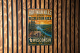 A vintage metal sign for Hoffman Hills State Recreation Area in Wisconsin, featuring a scenic landscape with a river, mountains, and trees.