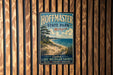 A vintage metal sign for Hoffman State Park in Michigan, featuring a scenic beach landscape with a pine tree and a lake in the background.