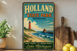 A vintage-style sign for Holland State Park in Michigan, featuring a lighthouse and beach scene, is displayed on a shelf next to a wooden cutting board and some lemons.