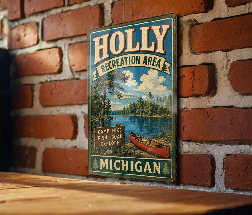 A vintage metal sign for the Holly Recreation Area in Michigan, featuring a scenic illustration of a lake, forest, and canoe.