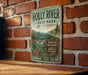 A vintage-style metal sign for Holly River State Park in West Virginia, featuring a scenic mountain landscape and the words "Wild and Wonderful Almost Heaven" and "Adventure Relax Explore".