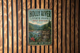 A vintage-style metal sign for Holly River State Park in West Virginia, featuring a scenic mountain landscape and a river.