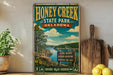 A vintage-style poster advertising Honey Creek State Park in Oklahoma, featuring a scenic landscape with a lake, mountains, and trees.